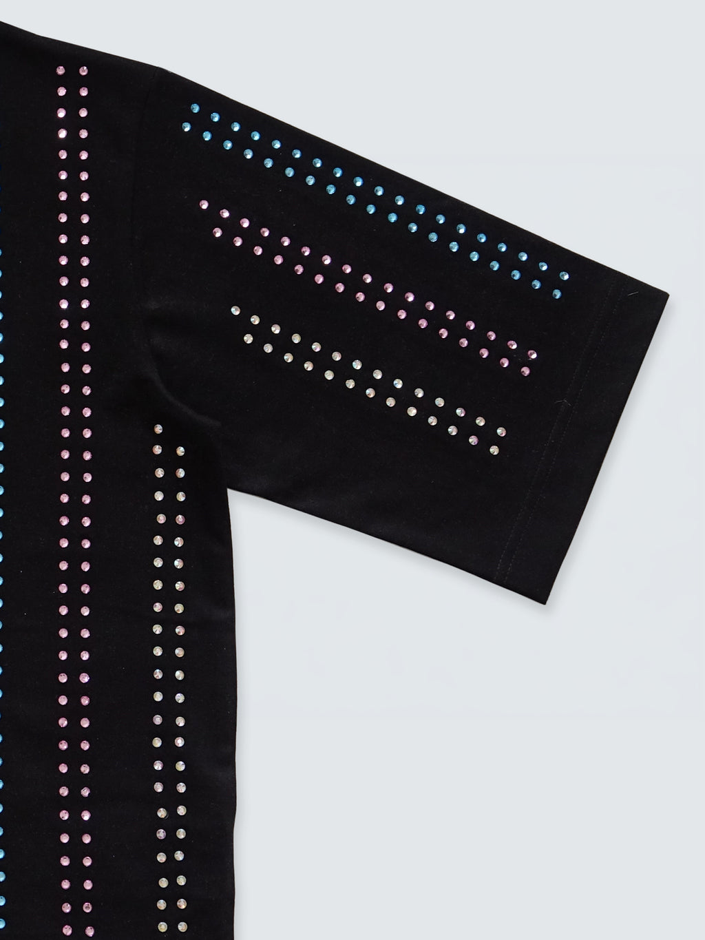 Close-up sleeve detail of black gender-free Proud T-shirt with rainbow crystal embellishment by Haus of Mx.